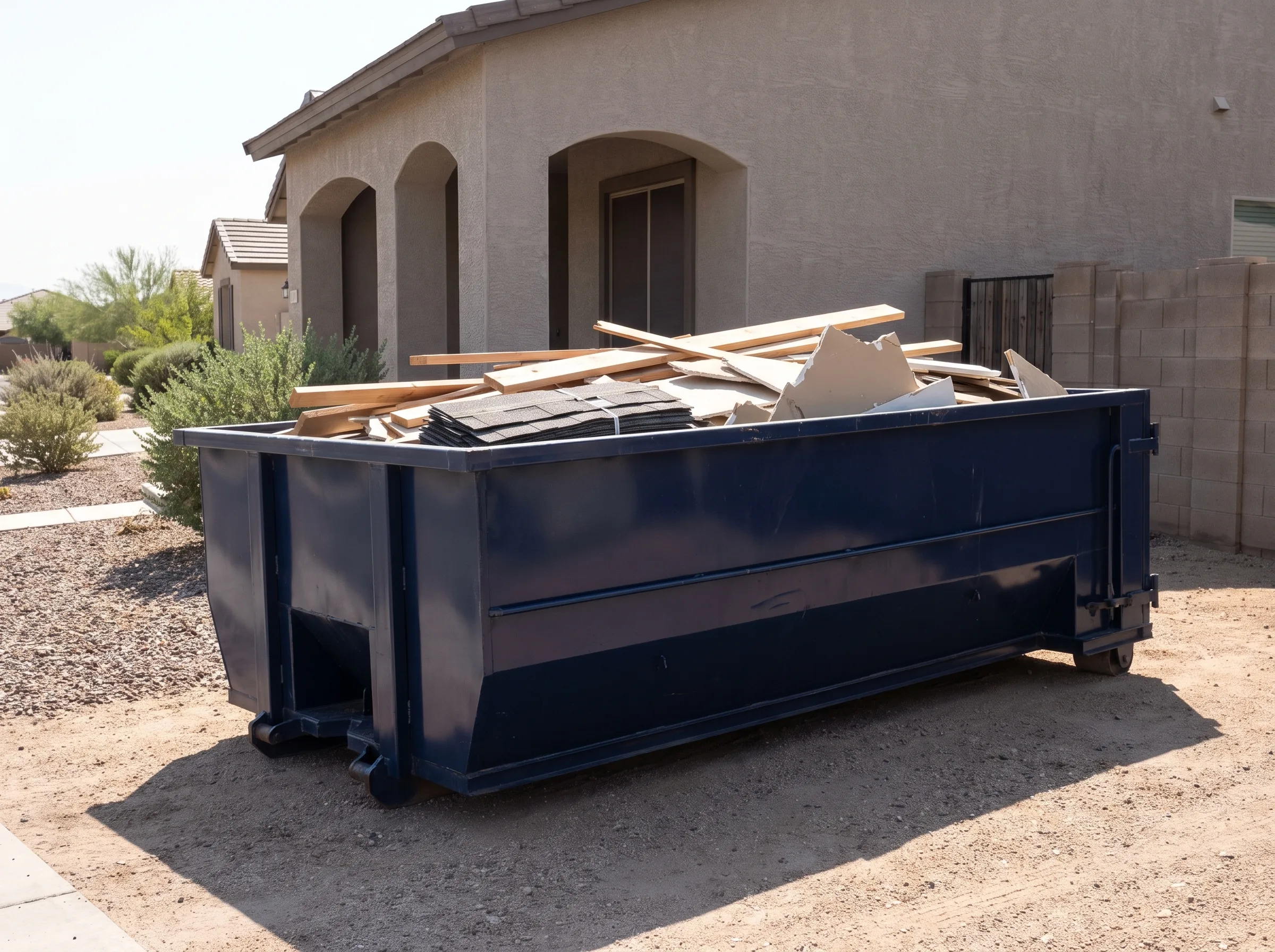 Roll-off dumpster being loaded in De Baca County, NM